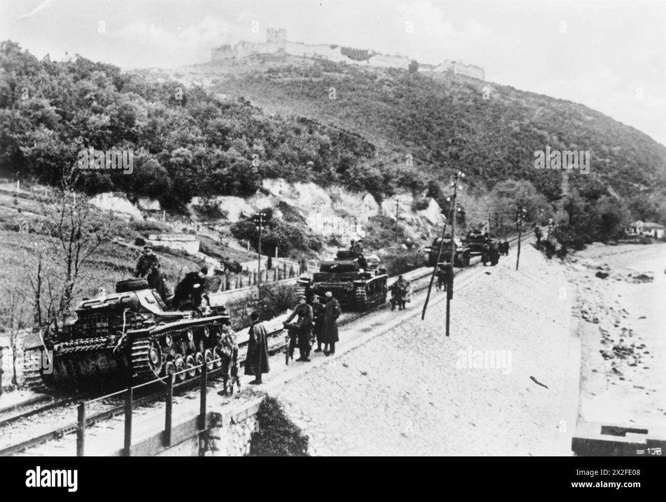 THE GERMAN INVASION OF GREECE, APRIL 1941 - German Panzer III tanks advance along a railway line in pursuit of retreating British troops in Greece between 25 and 30 April 1941 German Army Stock Photo
