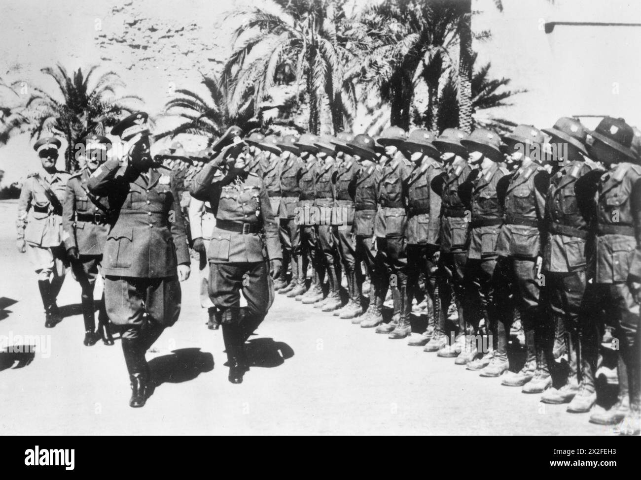 THE GERMAN ARMY IN THE WESTERN DESERT CAMPAIGN, 1941-1942 - General Erwin Rommel, the Commander of the German Afrika Korps, inspects his troops with General Garibaldo of Italy shortly after their arrival in North Africa, 21-31march 1941. The troops are wearing pith helmets German Army, Italian Army, Rommel, Erwin Johannes Eugen Stock Photo