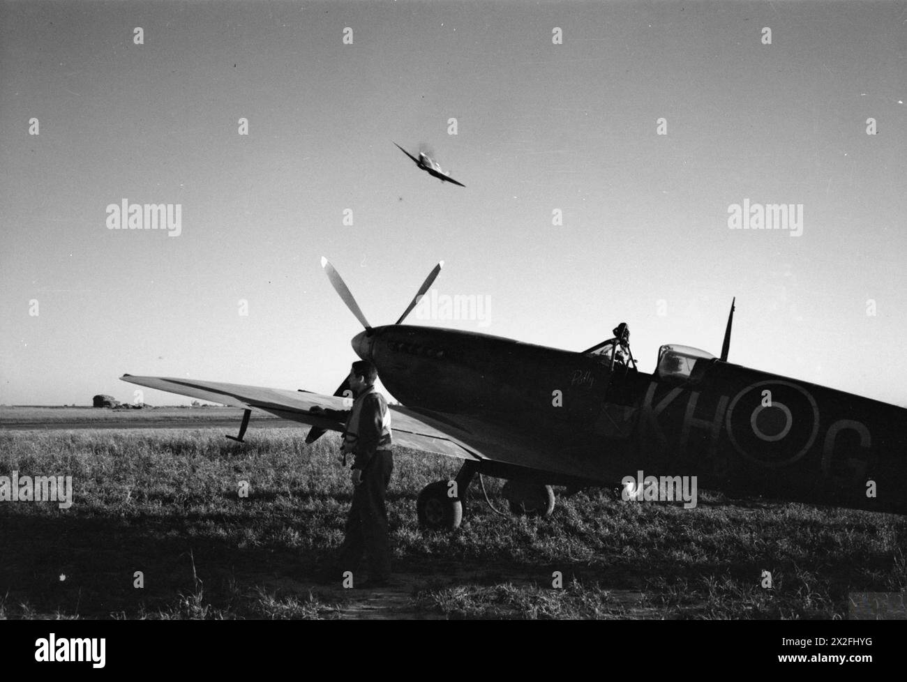 ROYAL AIR FORCE: 2ND TACTICAL AIR FORCE, 1943-1945. - A Supermarine Spitfire of No. 127 (Canadian) Wing takes off on a dusk patrol from B2/Bazenville, Normandy, while a Spitfire Mark IX of No. 403 Squadron RCAF waits at readiness Royal Canadian Air Force, 403 Squadron, Royal Air Force, Maintenance Unit, 201 Stock Photo