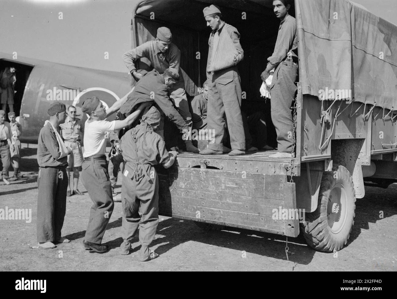 R.A.F. EVACUATE WOUNDED PARTISANS FROM YUGOSLAVIA - For story see CNA,3060 Picture (issued 1944) shows - Wounded being assisted on to a lorry for taking to the medical tents Stock Photo