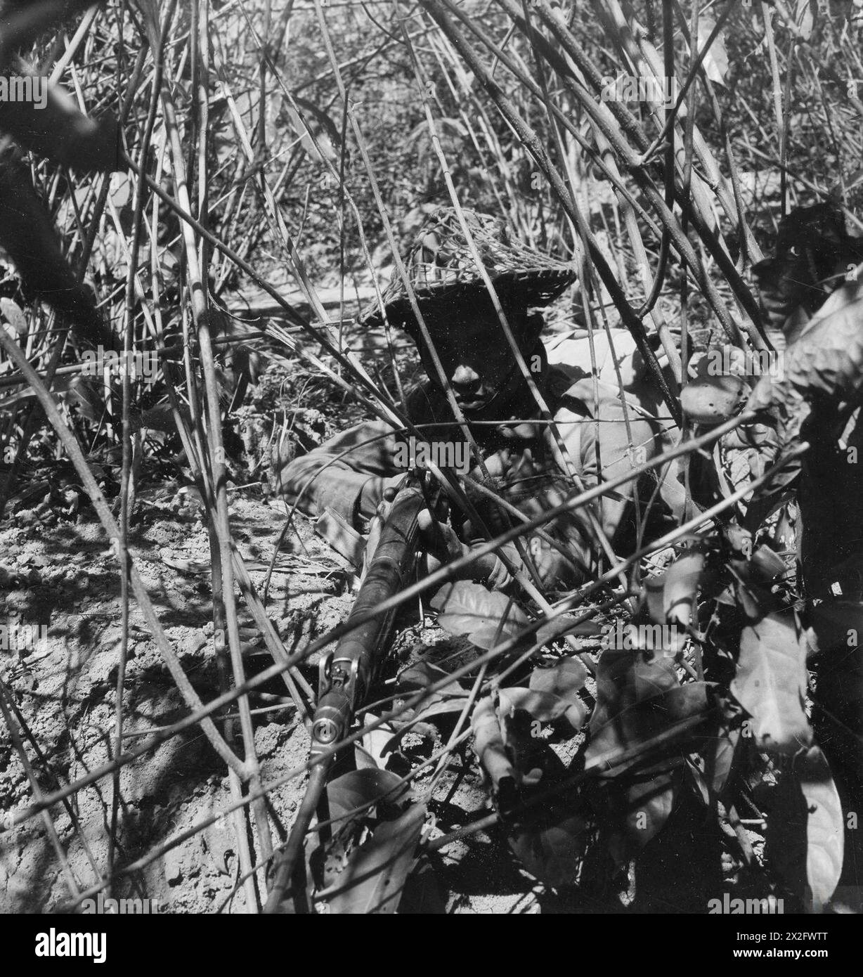 A Gurkha soldier occupies a camouflaged position in the Arakan jungle ...