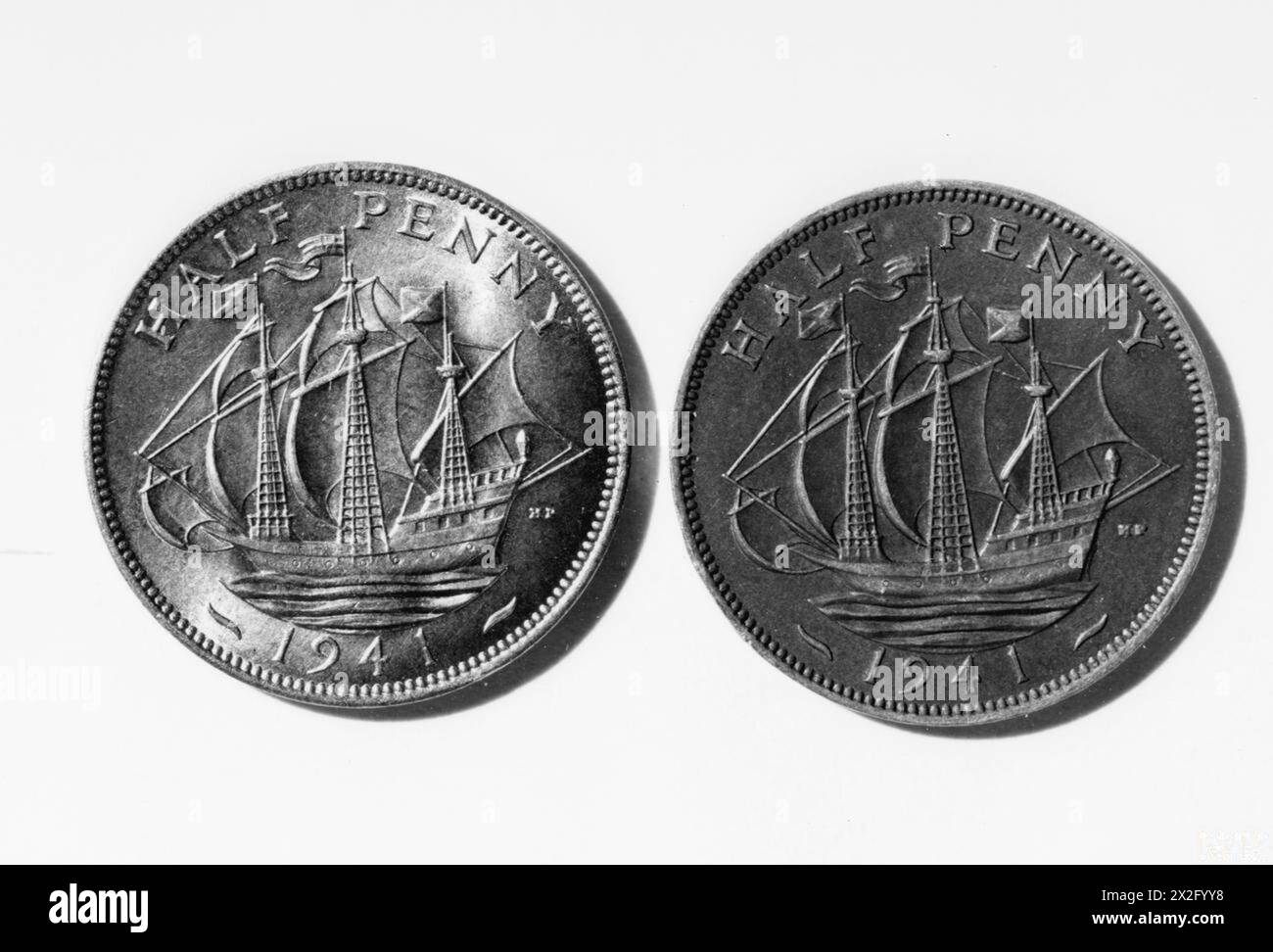 TWO HALFPENNIES SHOWING THE TAIL SIDES. DEPICTING A SAILING SHIP OF THE ELIZABETHAN ERA. - , Stock Photo