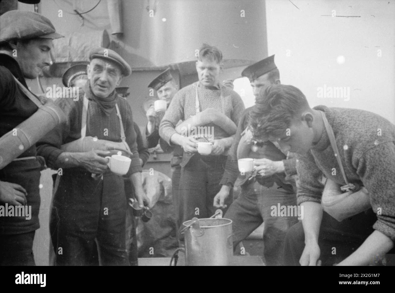 The rum ration is being issued to the crew on board the minesweeper HMT ...