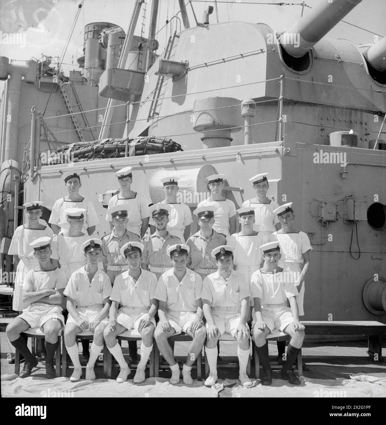 MEN OF THE HMS SUFFOLK, A CRUISER SERVING WITH ADMIRAL JAMES SOMERVILLE'S EASTERN FLEET. 12 DECEMBER 1943, TRINCOMALEE. THE MEN ARE DIVIDED INTO GROUPS BY TOWN AND/OR DISTRICT. - Middlesex group. Front row, left to right; Stoker R Grant, Feltham; OM Suckling, S Bush; EA S Admas, Hayes; EA D Hales, Isleworth; EA G Robinson, Ealing; AB S Wright, Hayes. Second row, left to right: AB Prentice, Hounslow; Tel R Haley, Ealing; Mne A Hodges, Hounslow; Mne V Willis, Hayes End; Mne R Tagg, Southall; Stoker G Ash, Cowely; Stoker A Clarke, S Bush. Third row, left to right: AB R Painter, Viewsley; Stoker F Stock Photo