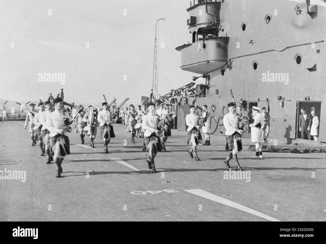 WITH THE HMS ILLUSTRIOUS DURING 1943. - Pipe band of the Royal Scots Regiment playing on board the ILLUSTRIOUS at Gibraltar. Supermarine Seafires in the background (October 1943) Stock Photo