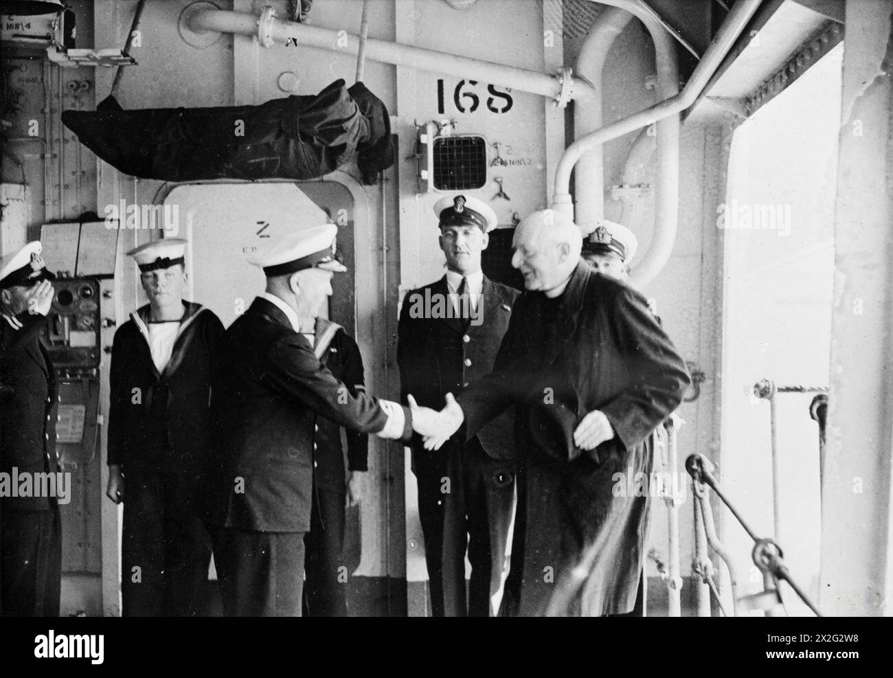 THE ARCHBISHOP OF YORK VISITS A CARRIER. 22 APRIL 1945, ON BOARD HMS VENERABLE, FLAGSHIP OF THE 11TH AIRCRAFT CARRIER SQUADRON. - His Grace being welcomed on board HMS VENERABLE by Rear Admiral Cecil Harcourt, CB, CBE Stock Photo