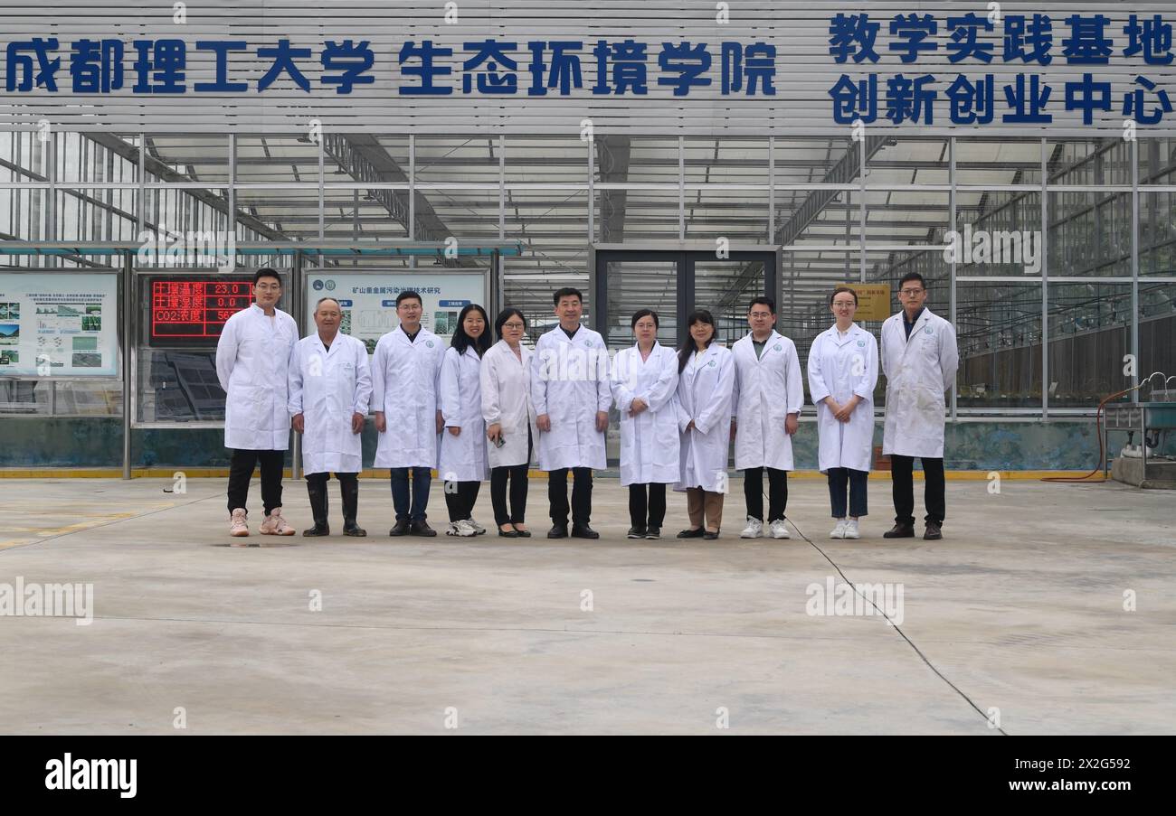 (240422) -- CHENGDU, April 22, 2024 (Xinhua) -- Pei Xiangjun (C) and his team pose for a group photo at the campus of Chengdu University of Technology in Chengdu, southwest China's Sichuan Province, April 20, 2024.  Jiuzhaigou National Park, a UNESCO World Heritage site famous for its spectacular waterfalls, lush forests and serene plateau lakes, was hit by a 7.0-magnitude quake on Aug. 8, 2017.    After the earthquake, a team led by professor Pei Xiangjun from Chengdu University of Technology carried out protection and restoration work of the natural heritage site. After years of post-quake r Stock Photo