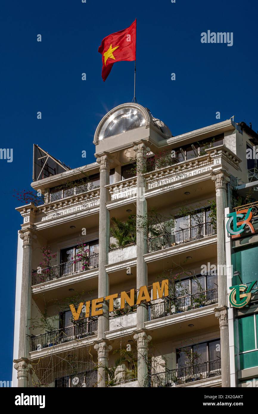 Vietnam, Ho Chi Minh City, Saigon, Buildings and Flag Stock Photo