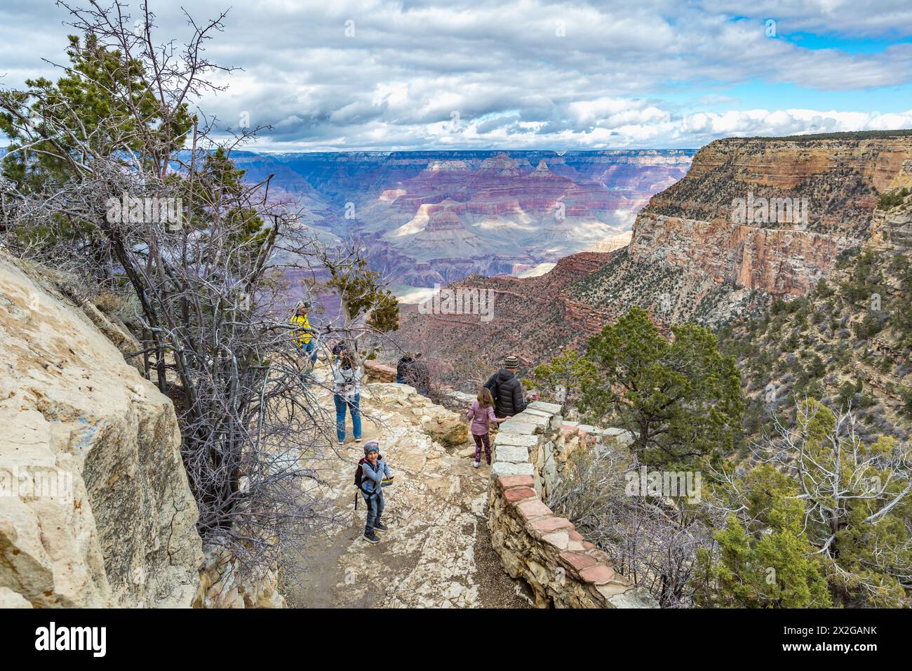 Tourists on the overlook at Lookout Studio along the South Rim of Grand Canyon National Park in Arizona Stock Photo