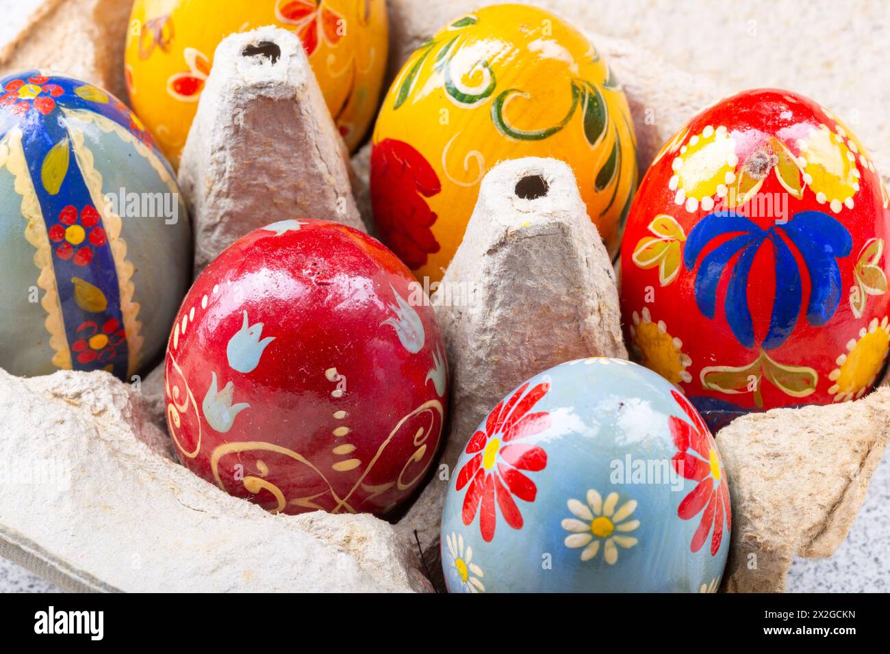 Colourful Hand painted easter eggs in an egg box Stock Photo