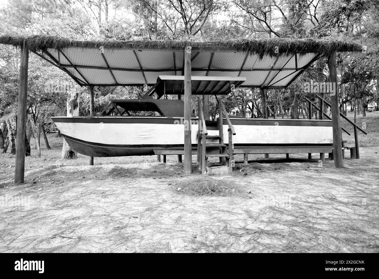 Wooden boat on display on a rural property for tourists to visit. monochrome Stock Photo