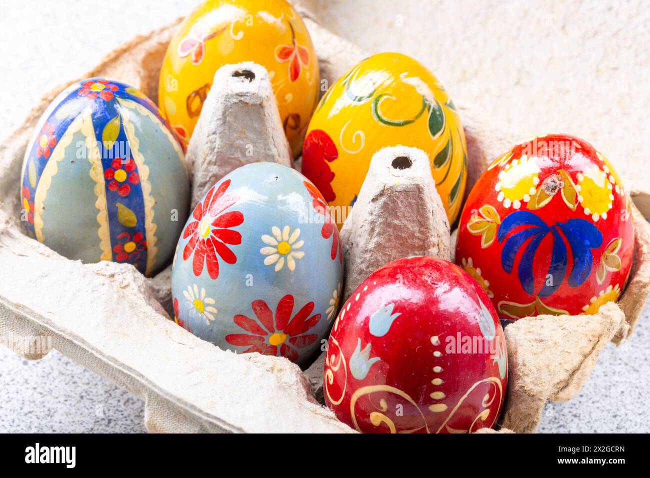 Colourful Hand painted easter eggs in an egg box Stock Photo