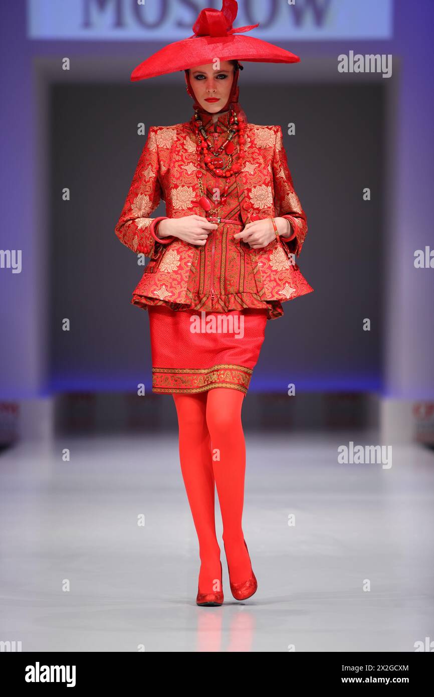 MOSCOW - FEBRUARY 22: Woman wear red suit from Slava Zaytzev walk the catwalk in the Collection Premiere Moscow, a fashion industry platform of IGEDO Stock Photo