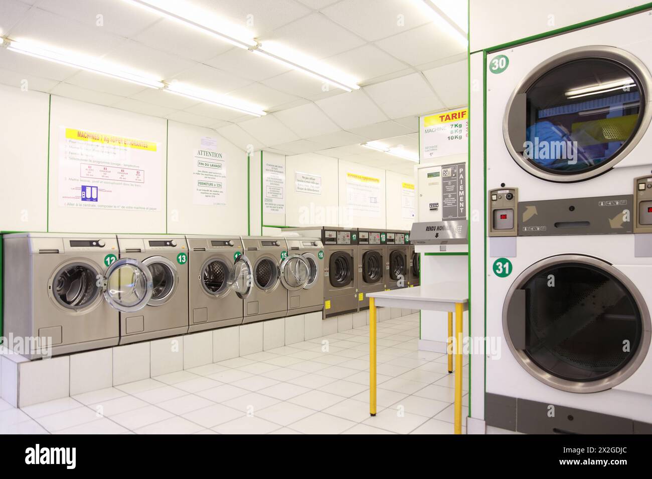 number of washing machines in empty public laundry, clean and light Stock Photo