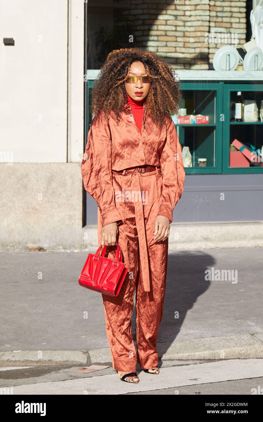 MILAN, ITALY - FEBRUARY 24 , 2024: Woman with red Ferrari bag and ...