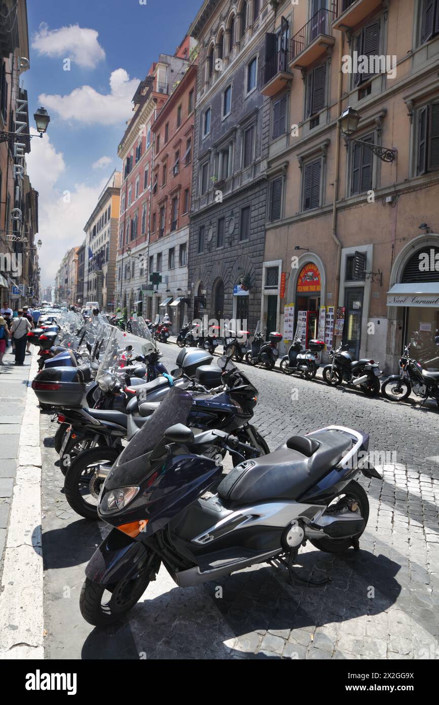 ROME - AUGUST 4: Rows of motorcycles and tourists on streets of Rome on August 4, 2010 in Rome, Italy. In Rome tax on tourists came into effect. Stock Photo