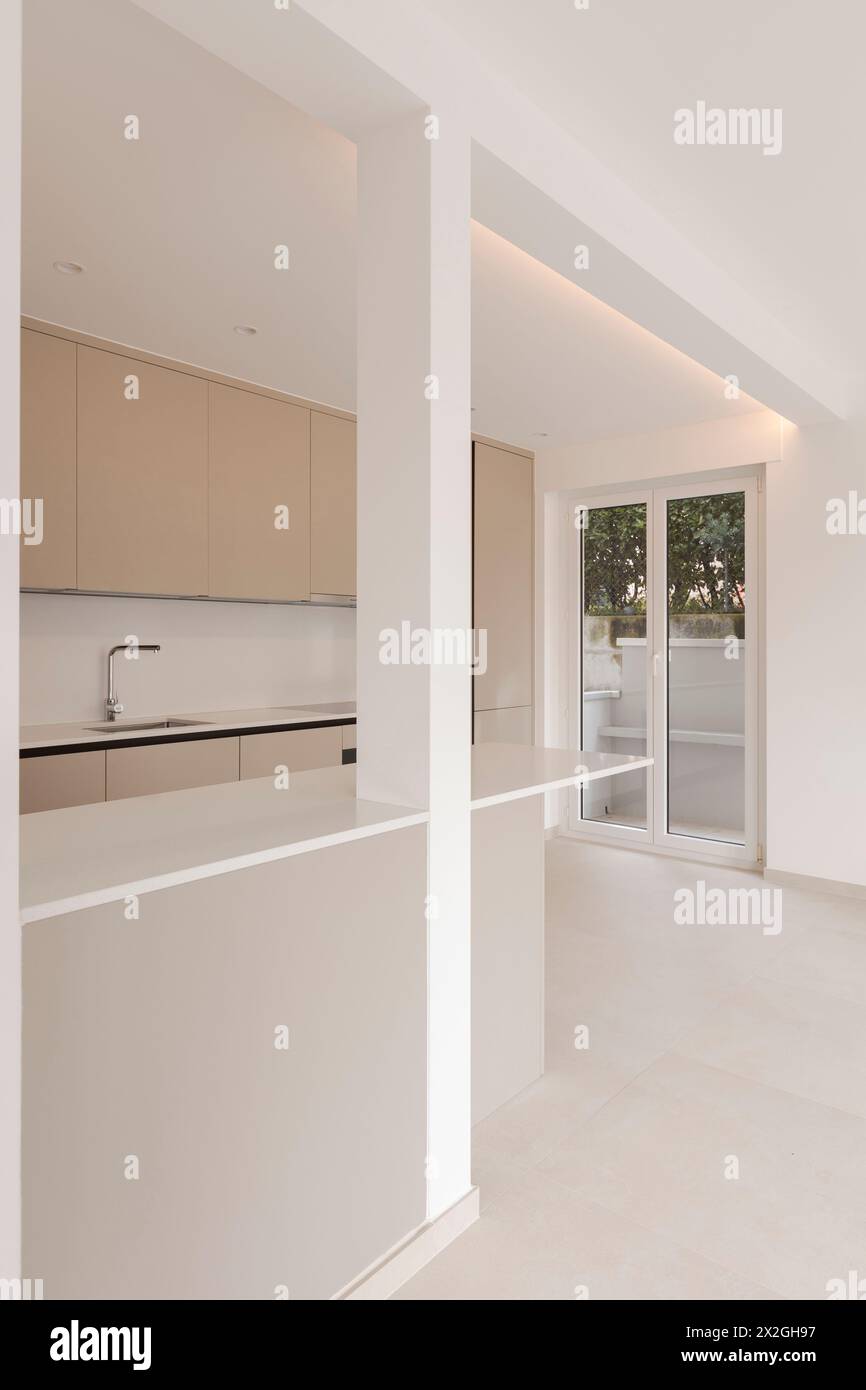 Interior of a new empty modern kitchen in brown beige. Empty flat, no furniture. Great attention to detail. Stock Photo