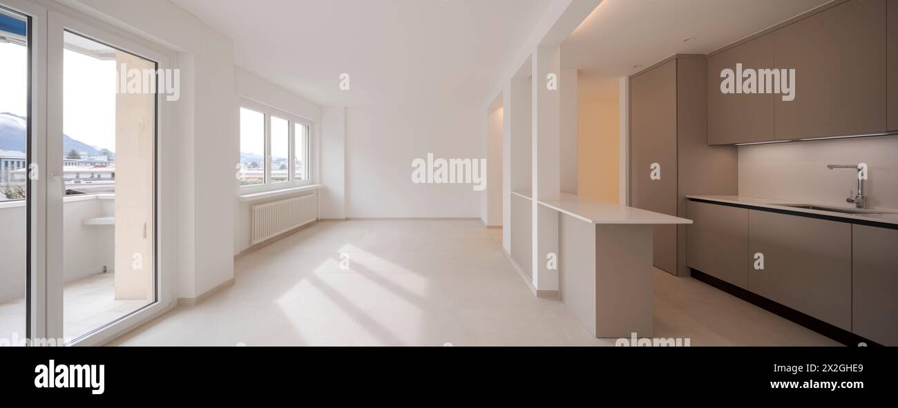 Interior of a new empty modern kitchen in brown beige. Empty flat, no furniture. Great attention to detail. Stock Photo