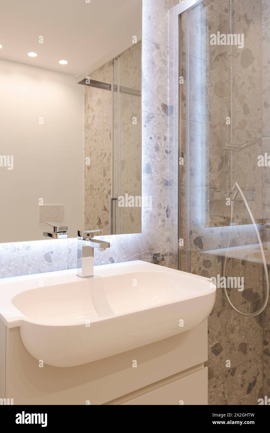 Inside a modern bathroom with marble tiles. Detail of the sink. Stock Photo