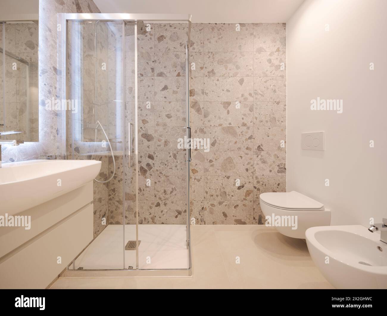 Inside a modern bathroom with marble tiles. Front view of the shower. Stock Photo