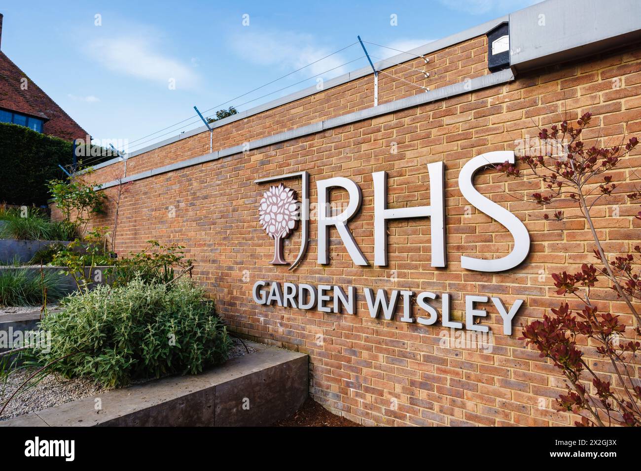 The RHS logo and name sign at the entrance to the RHS Garden, Wisley, Surrey, south-east England in spring Stock Photo