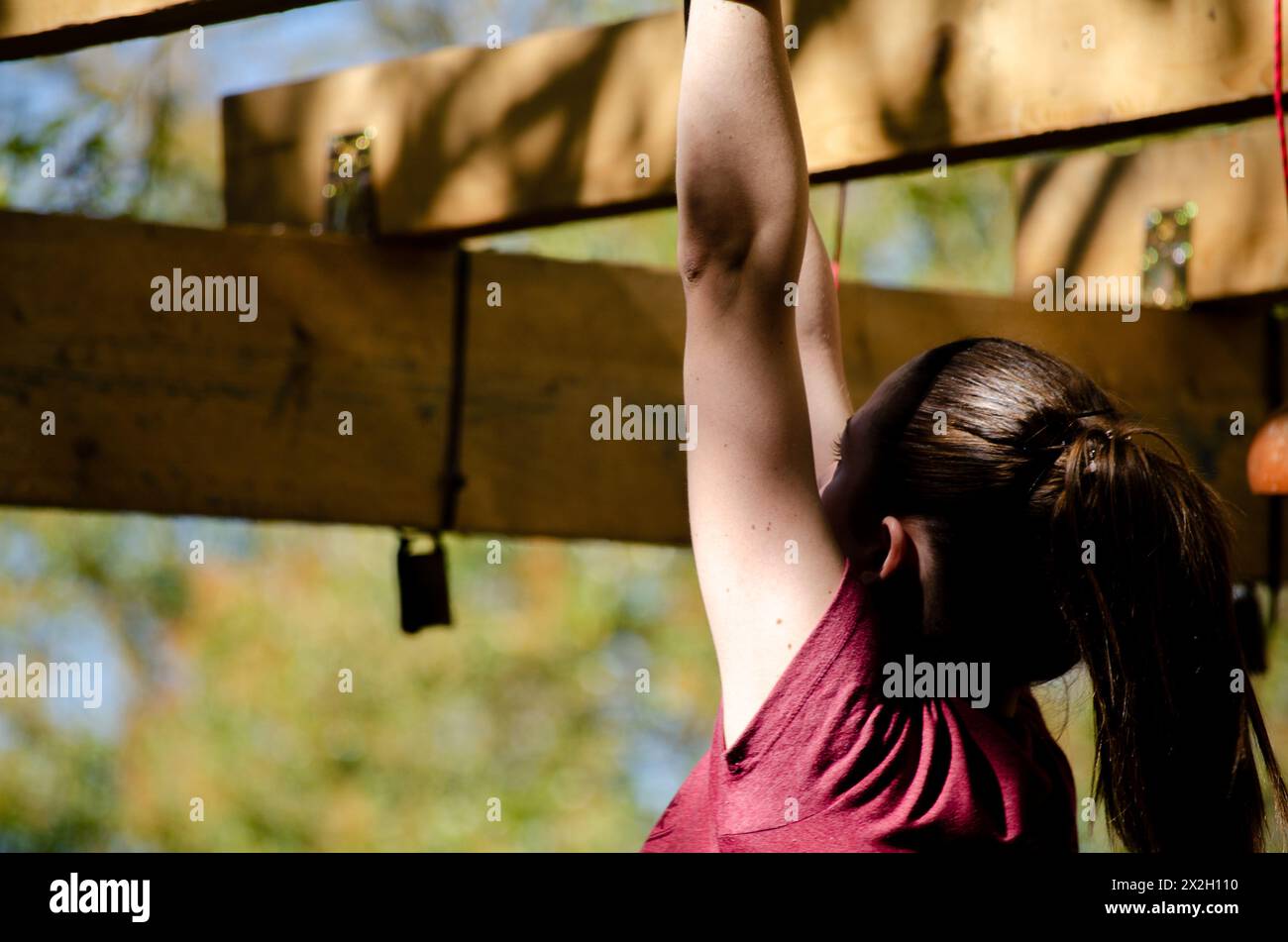 athlete hand at a hanging obstacle at an obstacle course race, OCR Stock Photo