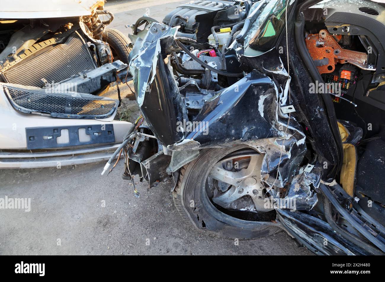 Crumpled and broken hoods of two collided cars after accident Stock