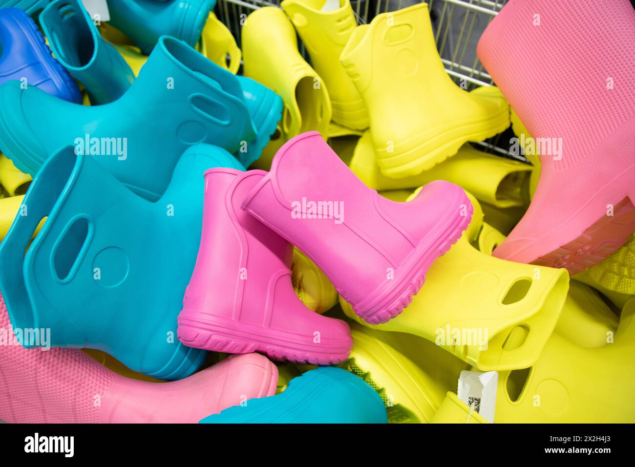 Childlike multi-colored rubber boots in the store Stock Photo