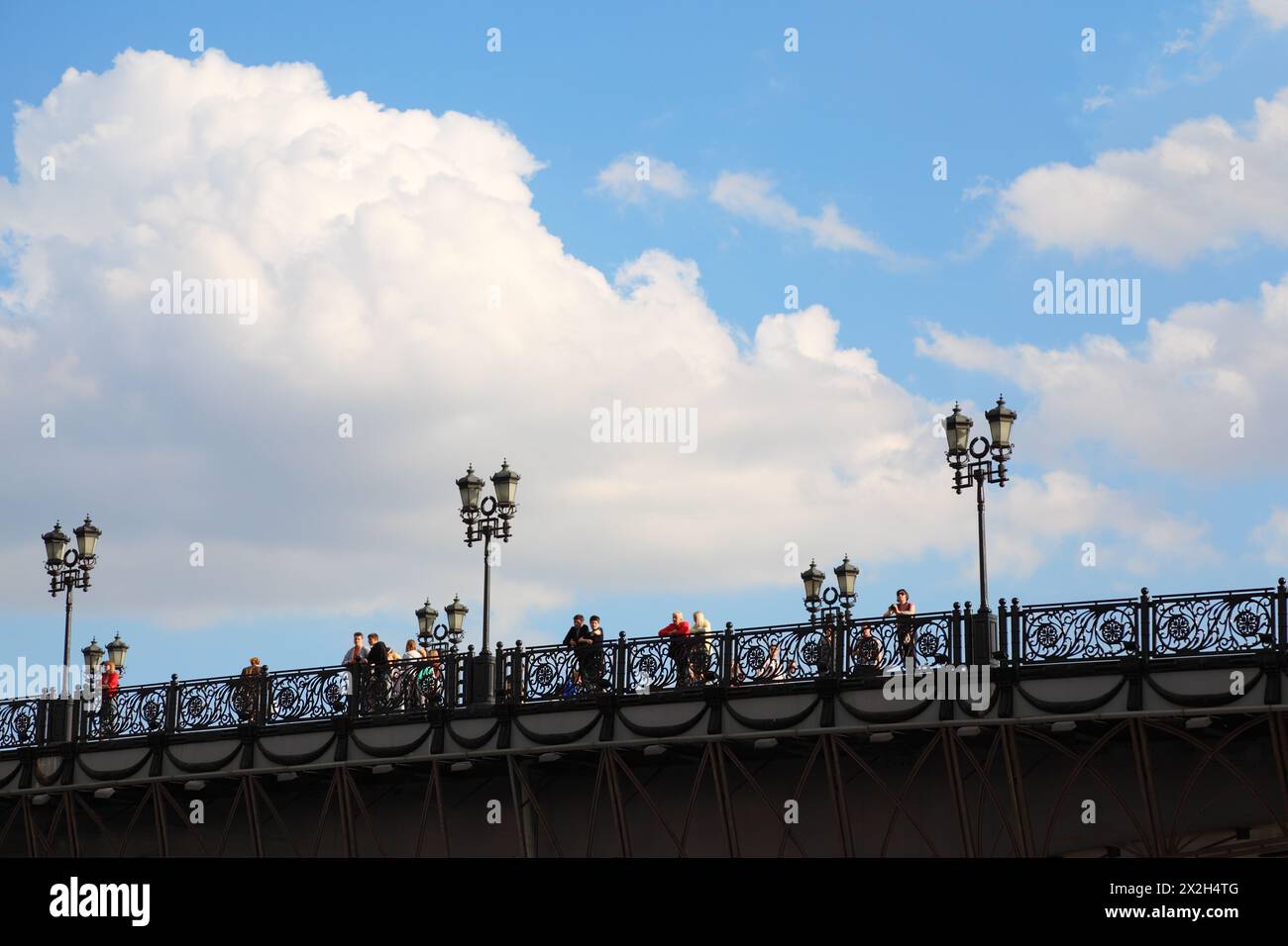 MOSCOW - MAY 29: People on Patriarchal Bridge on May 29, 2010 in Moscow, Russia. Patriarchal Bridge - pedestrian bridge in Moscow, which was opened in Stock Photo