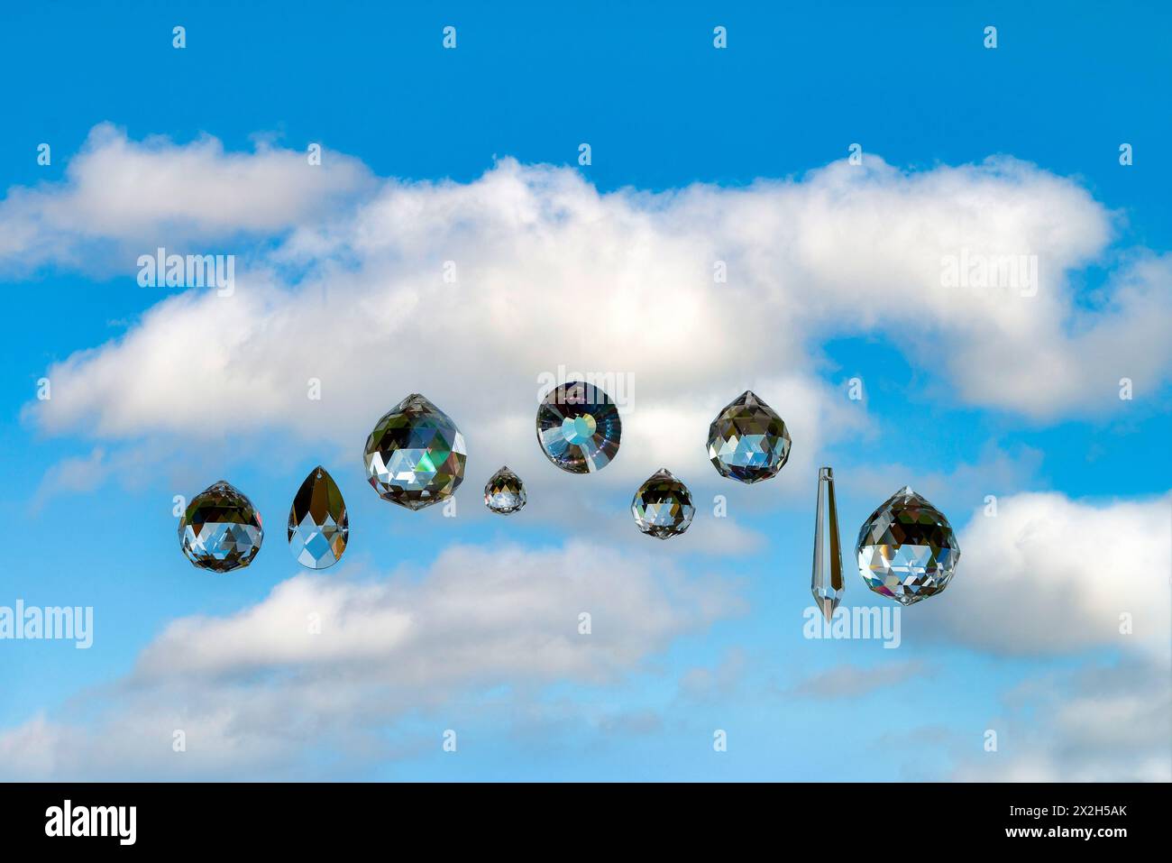 Nine faceted crystals with a cloudy sky as backdrop Stock Photo