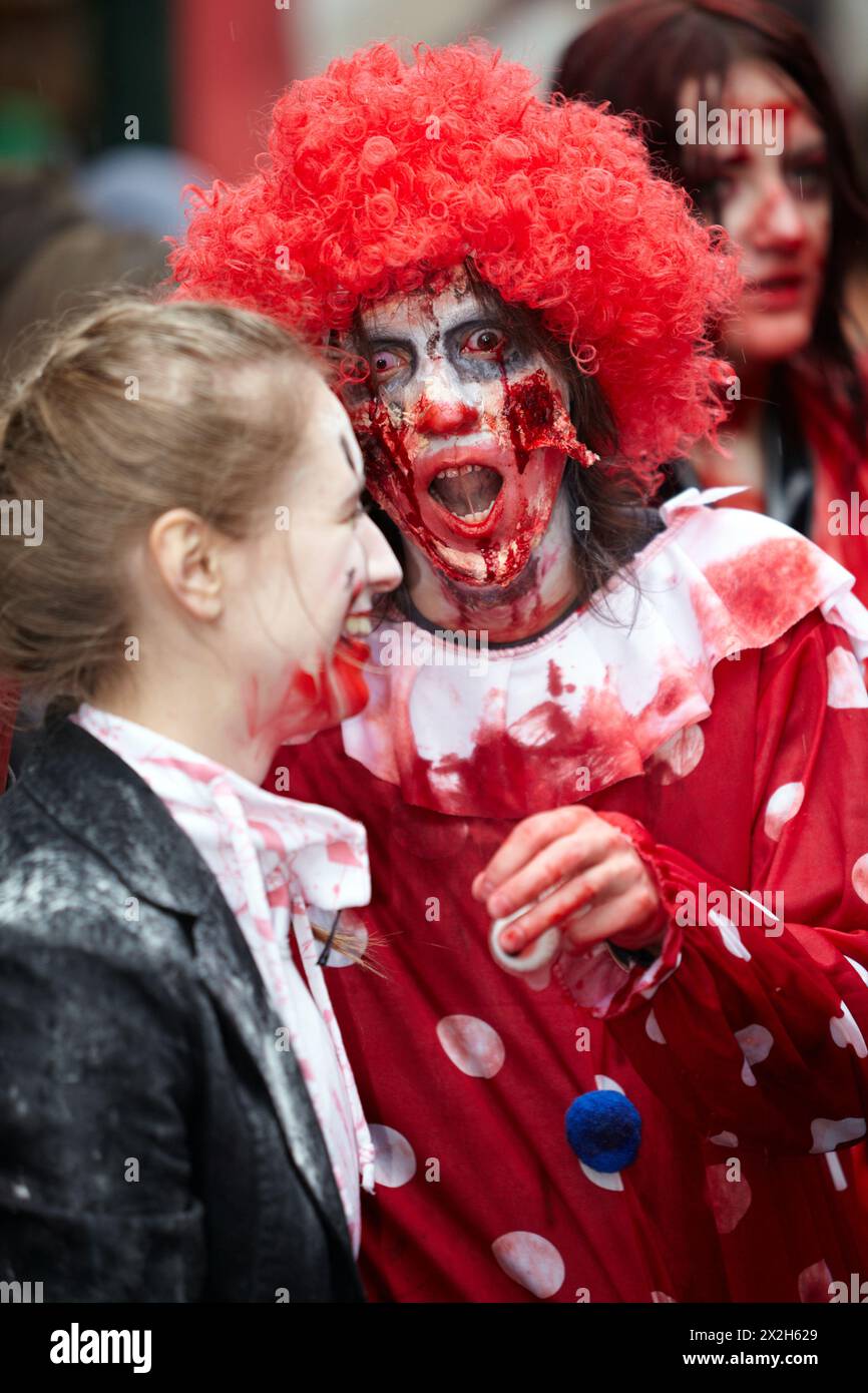 MOSCOW - MAY 14: Unidentified participants - red-haired curly dreadful clown and laughing made-up girl - at Zombie Parade on Old Arbat, May 14, 2011, Stock Photo