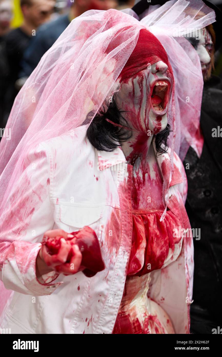 MOSCOW - MAY 14: Shouting out live dead bride participant with a viscera in the hand and with a bloody bandage on the eyes at Zombie Parade on Old Arb Stock Photo