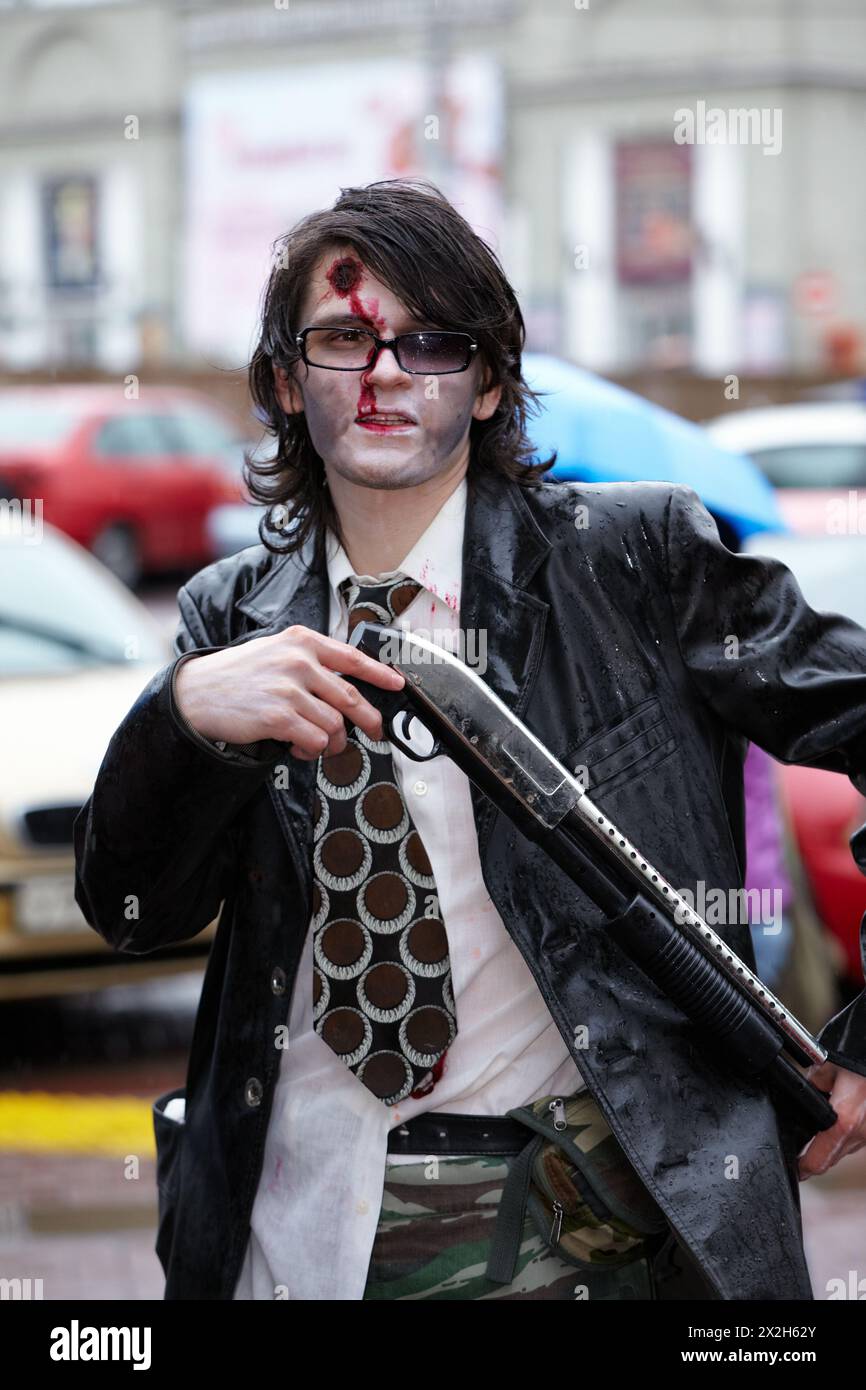 MOSCOW - MAY 14: Unidentified made-up participant of Zombie Parade on Old Arbat with shotgun in his hands, May 14, 2011, Moscow, Russia. Stock Photo