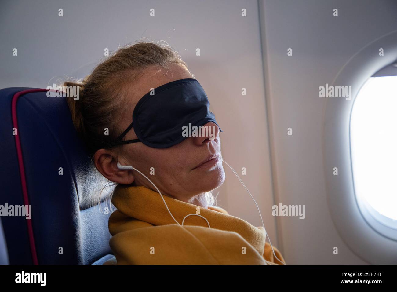 woman sleeping during a flight Stock Photo