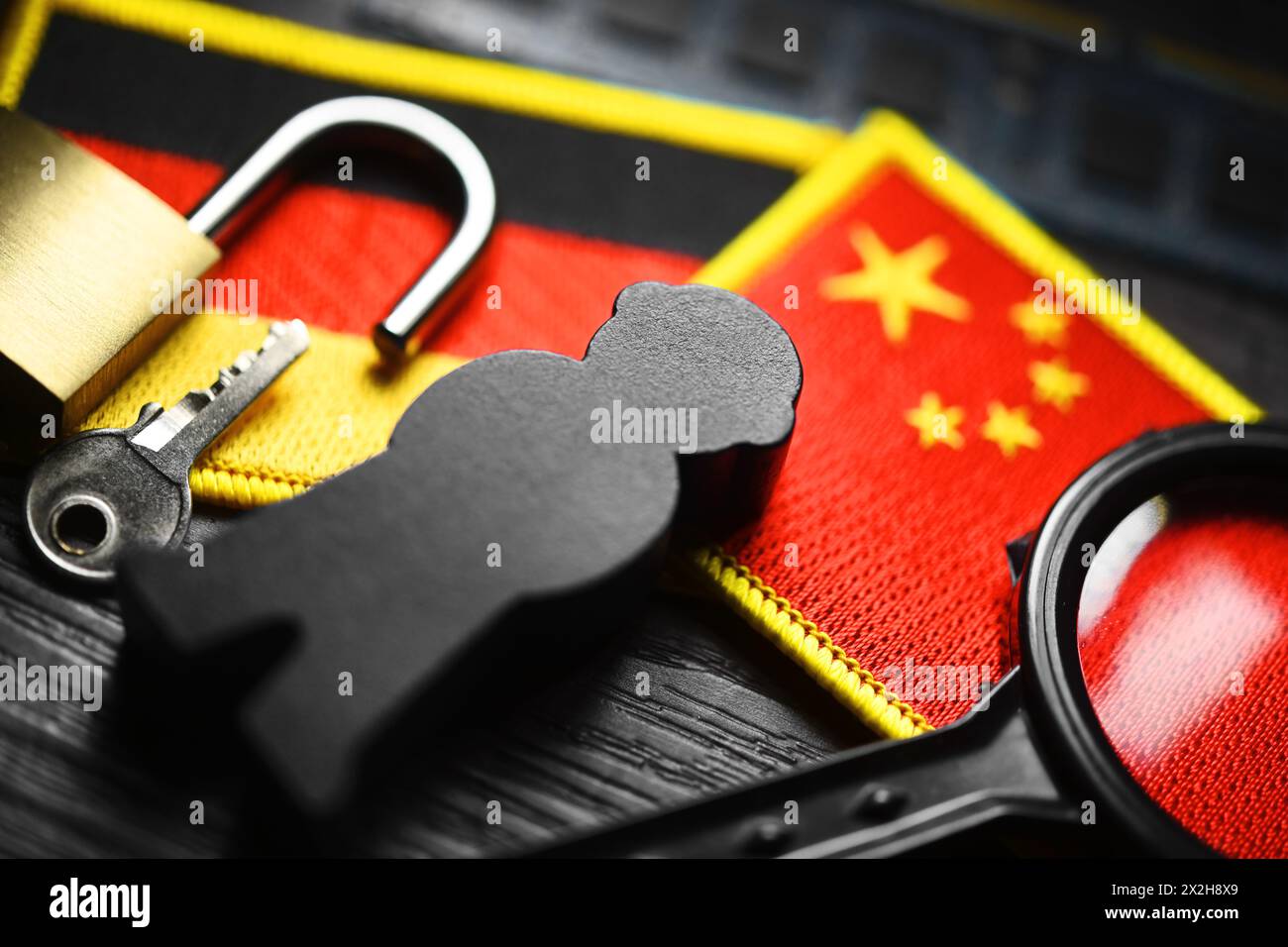 Black figure on the flags of Germany and China, symbolic photo of Chinese espionage Stock Photo