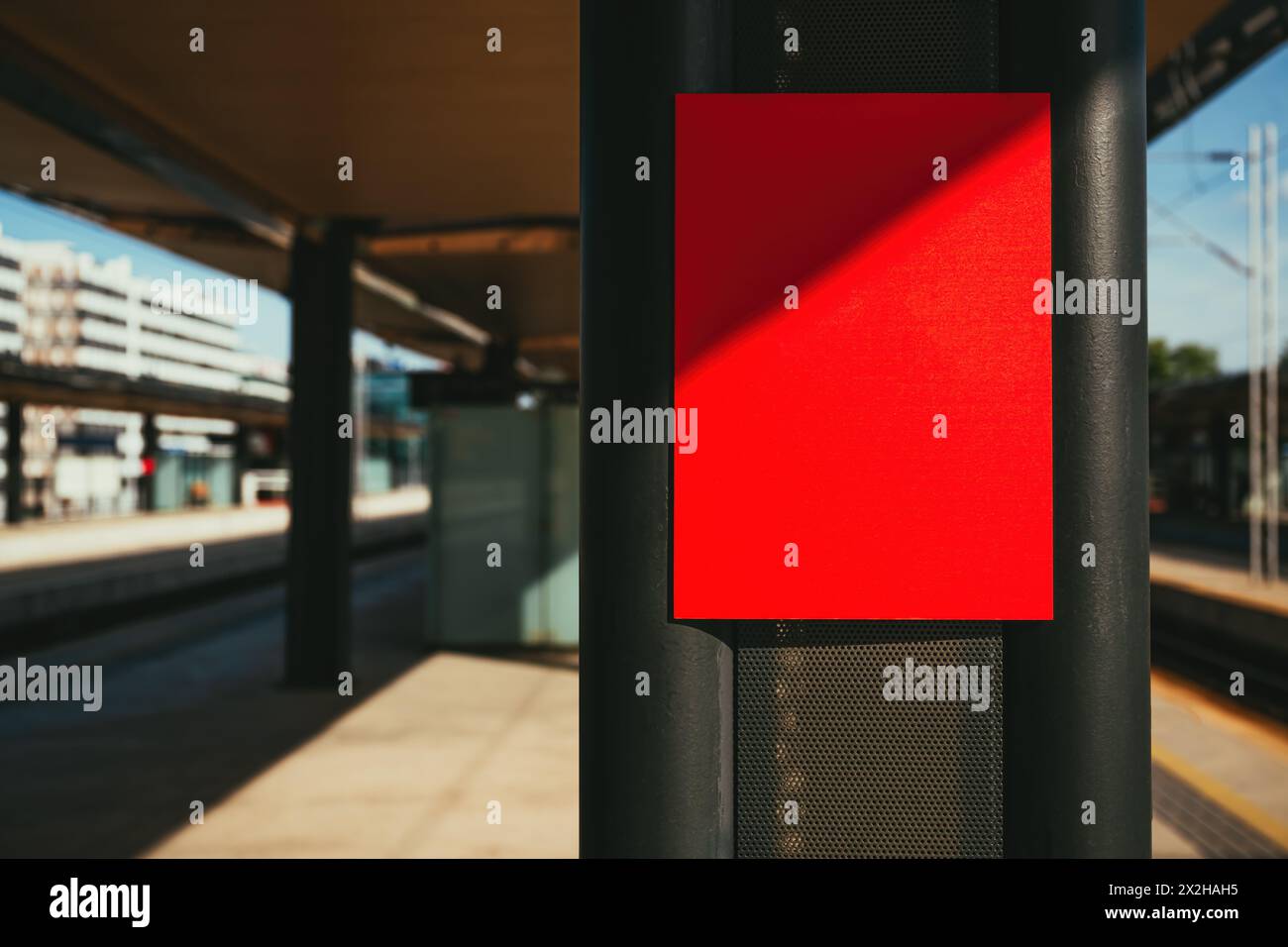 Red information sign board mockup on train station, selective focus Stock Photo
