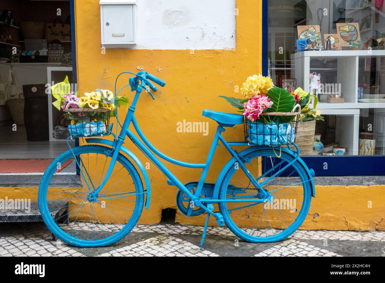 Traditional Painted Blue Bicycle With Carrier Baskets Used As A Display Outside A Retail Shop In Ponta Delgada, The Azores, Portugal, April 13, 2024 Stock Photo