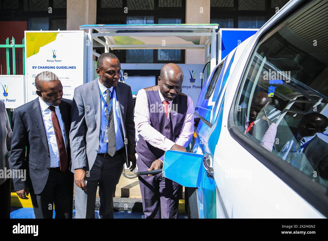 Nairobi, Kenya. 22nd Apr, 2024. Kenya Power Managing Director Joseph Siror (R) charges a JAC electric vehicle from China in Nairobi, Kenya, on April 22, 2024. Kenya Power, the country's electricity distributor, said on Monday that it will invest 1.93 million U.S. dollars in the next three years to spur the adoption of electric vehicles (EVs) in the country. Credit: Allan Mutiso/Xinhua/Alamy Live News Stock Photo