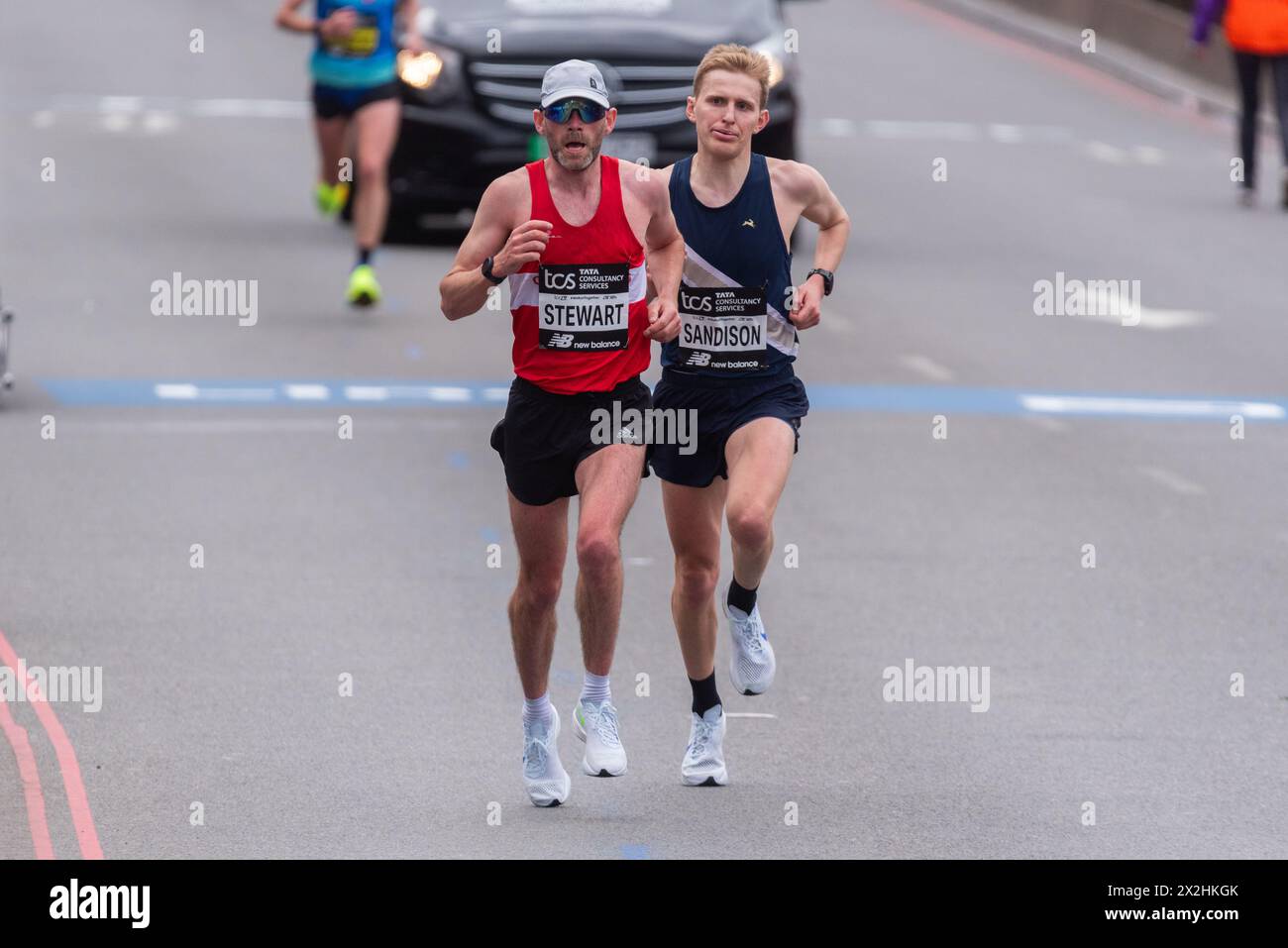 Fraser Stewart & Charlie Sandison competing in the TCS London Marathon 2024 passing through Tower Hill, London, UK. Stock Photo