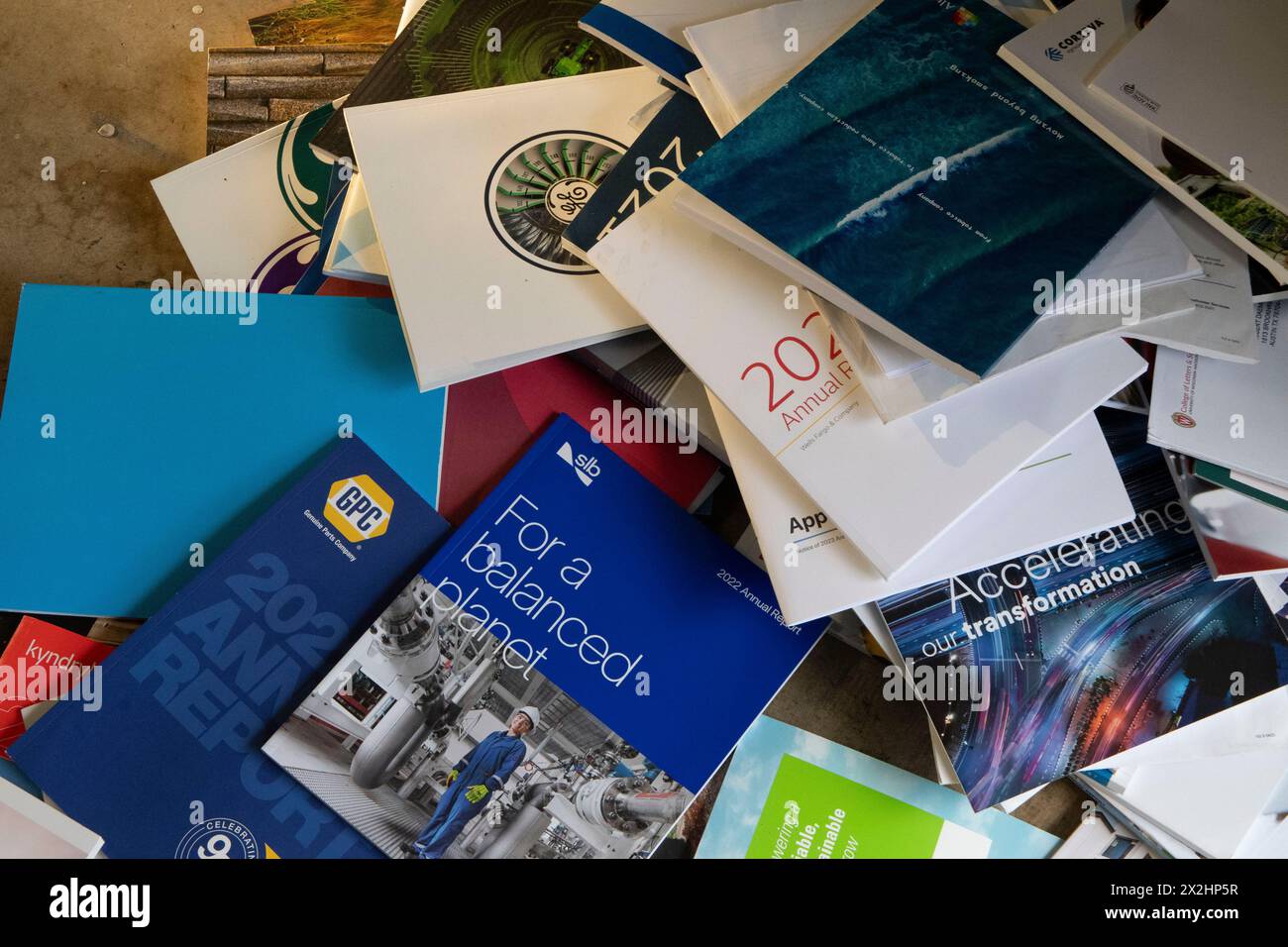 A pile of mostly unread corporate annual reports overflow from a household trash bin in Austin, Texas. Many corporations have scaled back costly annual report deliveries, opting for online access to shareholders who don't want or need an expensive paper copy. Stock Photo