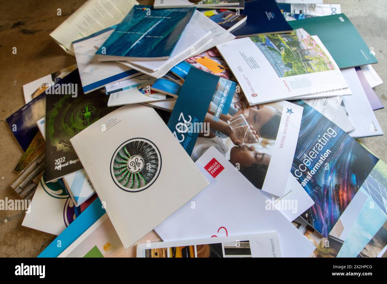 A pile of mostly unread corporate annual reports overflow from a household trash bin in Austin, Texas. Many corporations have scaled back costly annual report deliveries, opting for online access to shareholders who don't want or need an expensive paper copy. Stock Photo