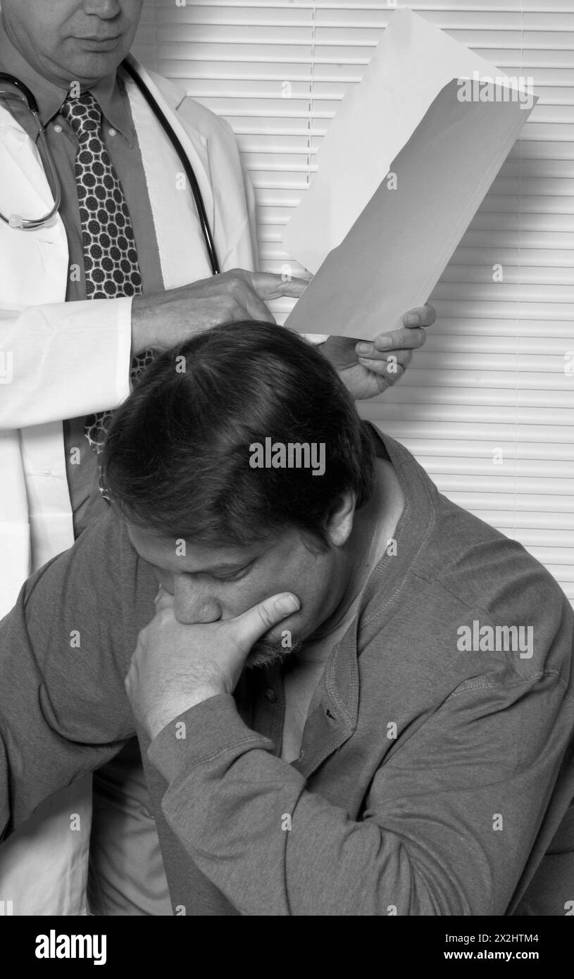 Male Caucasian Doctor Going Over Patient's Results Stock Photo