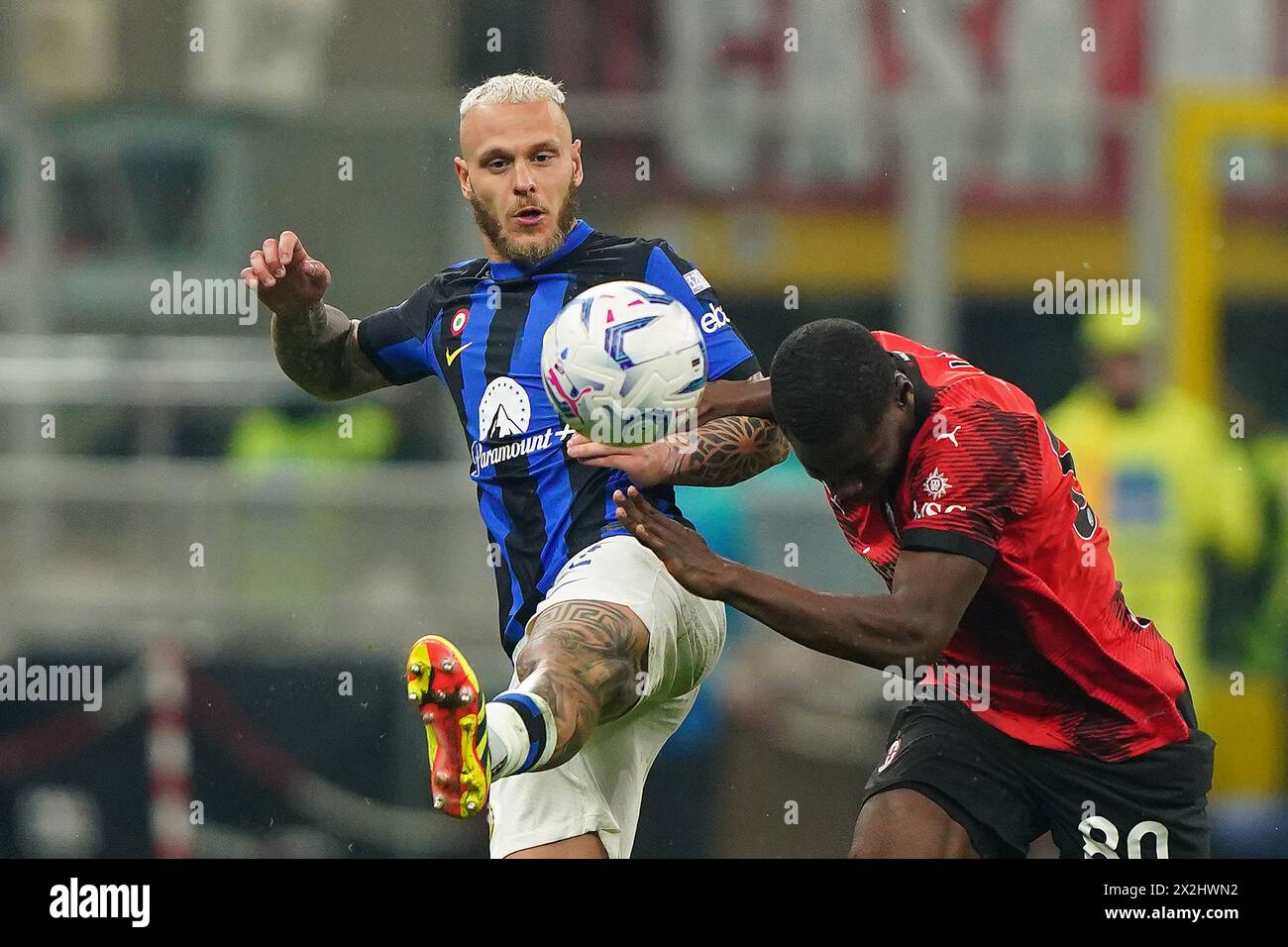 Inter's Federico Dimarco fights for the ball with AC Milan's Yunus Musah during the Serie A soccer match between Milan and Inter at San Siro stadium, north Italy - Monday 22, April, 2024. Sport - Soccer . (Photo by Spada/LaPresse) Credit: LaPresse/Alamy Live News Stock Photo