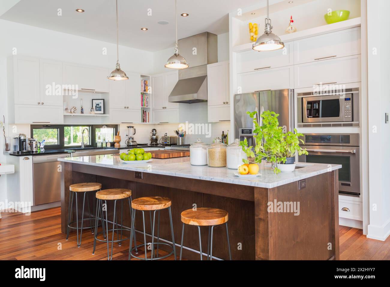 Kitchen area with white marble top wooden island with painted
