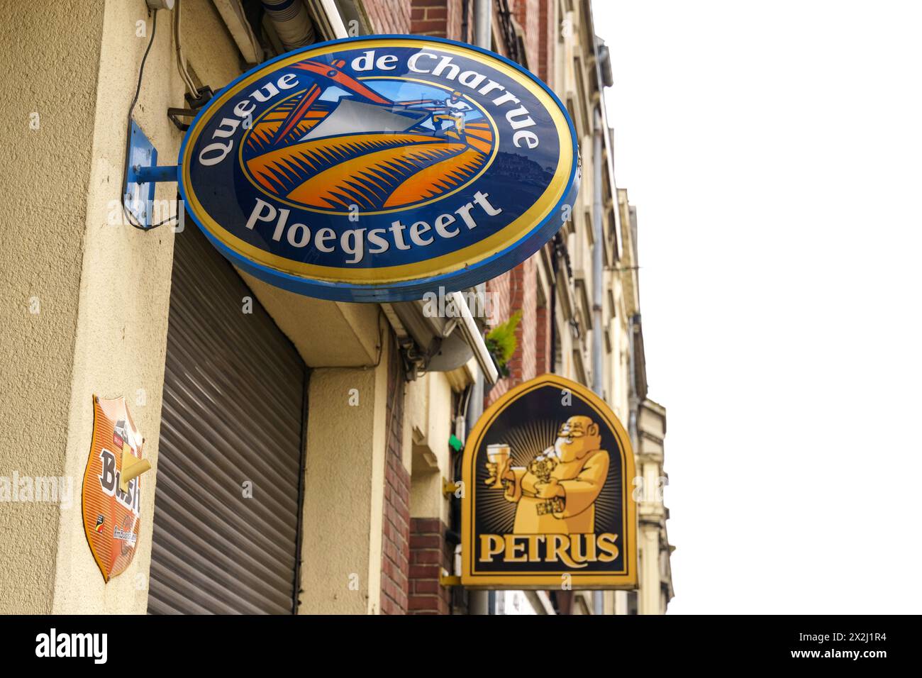 Cambrai, France - May 21, 2023: A collection of vibrant, round Belgian beer signs mounted on the exterior wall of a building, featuring traditional br Stock Photo