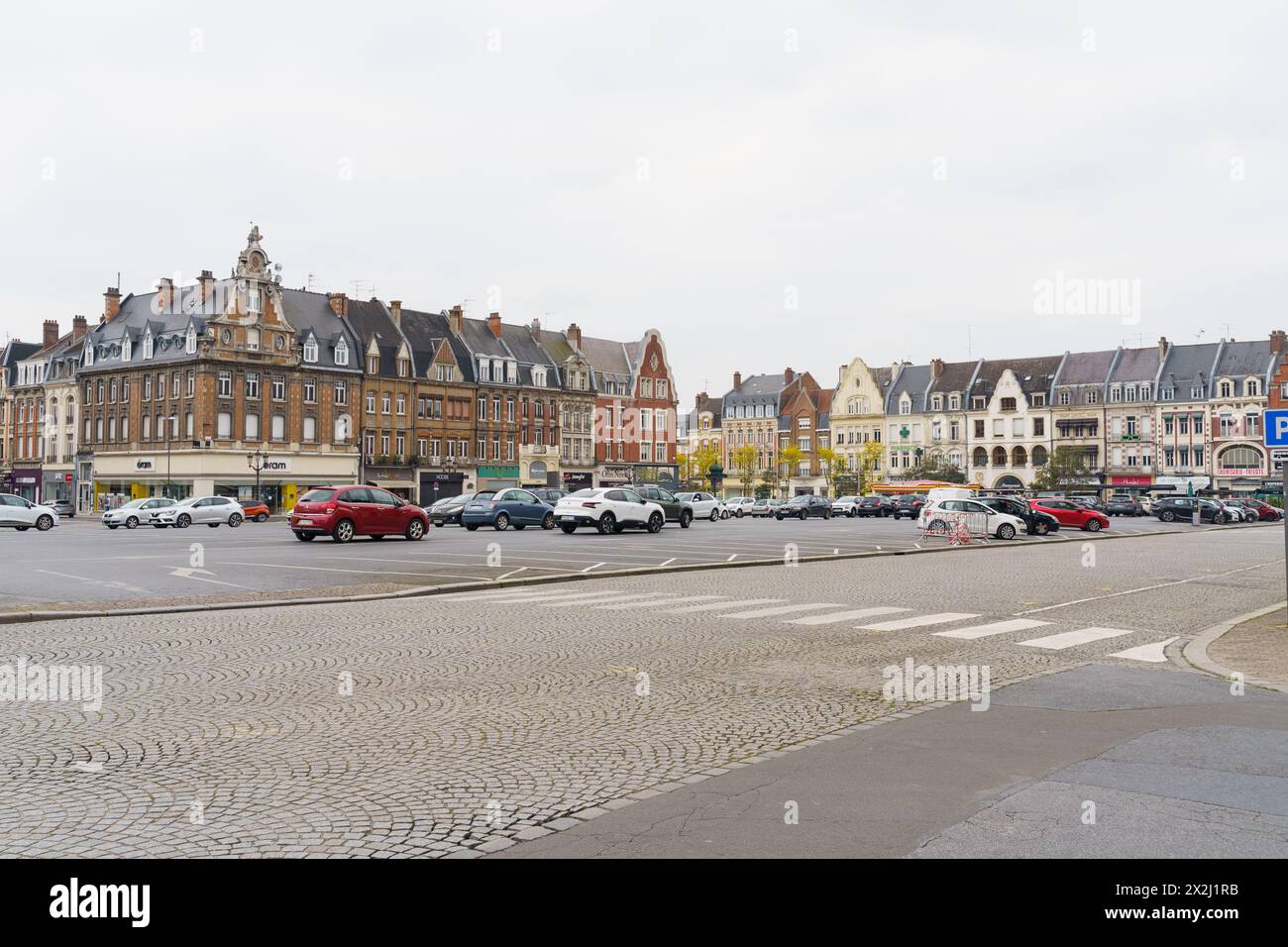 Cambrai, France - May 21, 2023: A city street filled with heavy traffic passing by tall buildings. Cars and buses navigating through the busy urban en Stock Photo