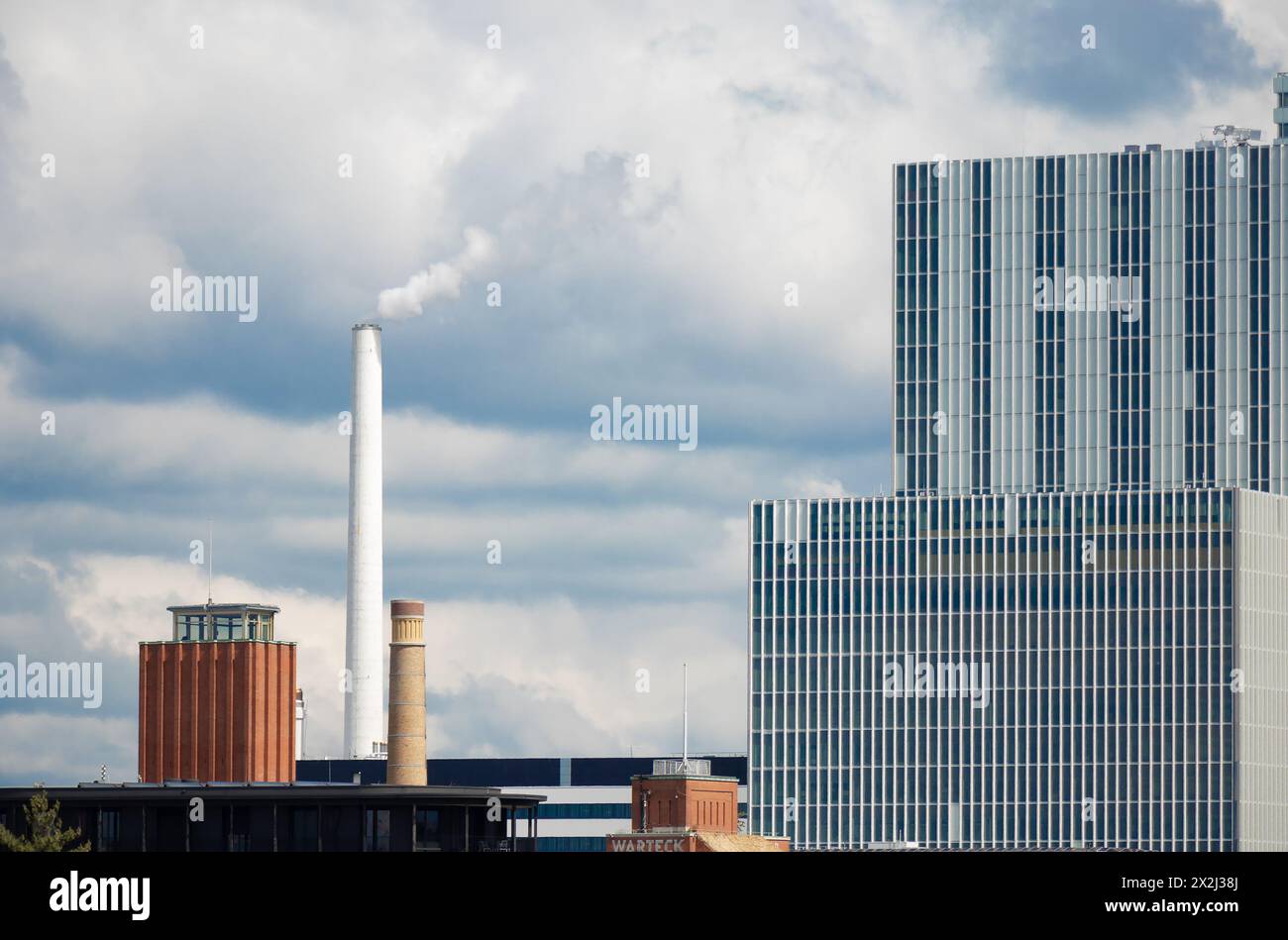 Basel, Switzerland - April 18, 2024: Cityscape with Warteck brewery and Roche pharma industry buildings complex with smokestacks Stock Photo
