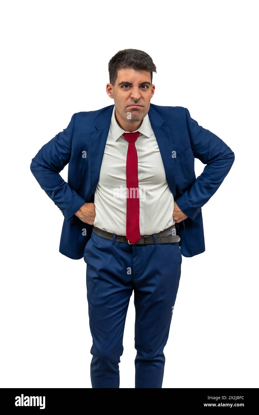vertical intense fury of a businessman as he glares furiously at the camera, with hands on hips displaying an attitude of anger and frustration.he emb Stock Photo