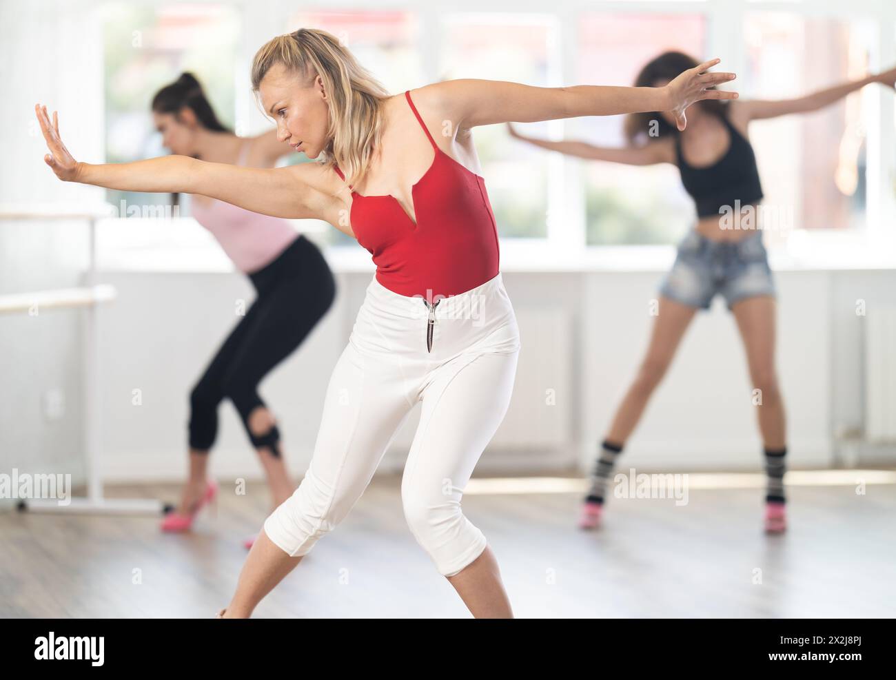 Adult woman dancing high heels in group Stock Photo - Alamy