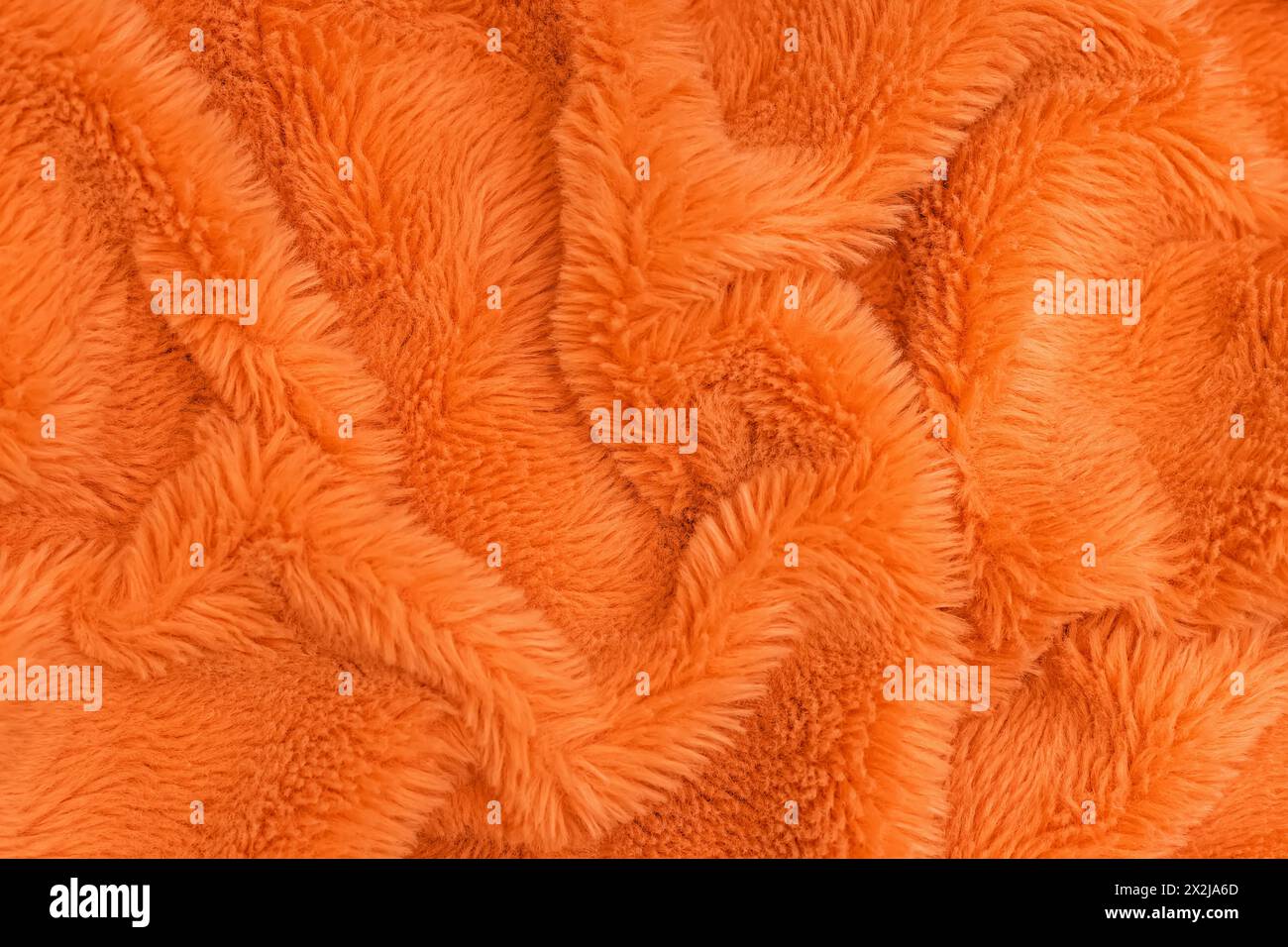 Bright orange faux fur texture, fabric background Stock Photo